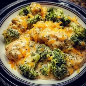 Creamy broccoli cheddar chicken dish prepared in a crockpot with fresh ingredients.