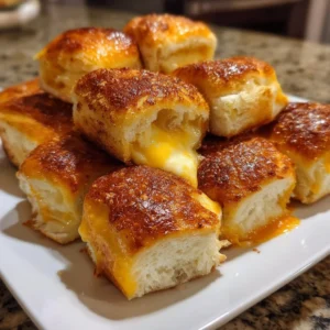 Mini grilled cheese Hawaiian rolls served on a platter